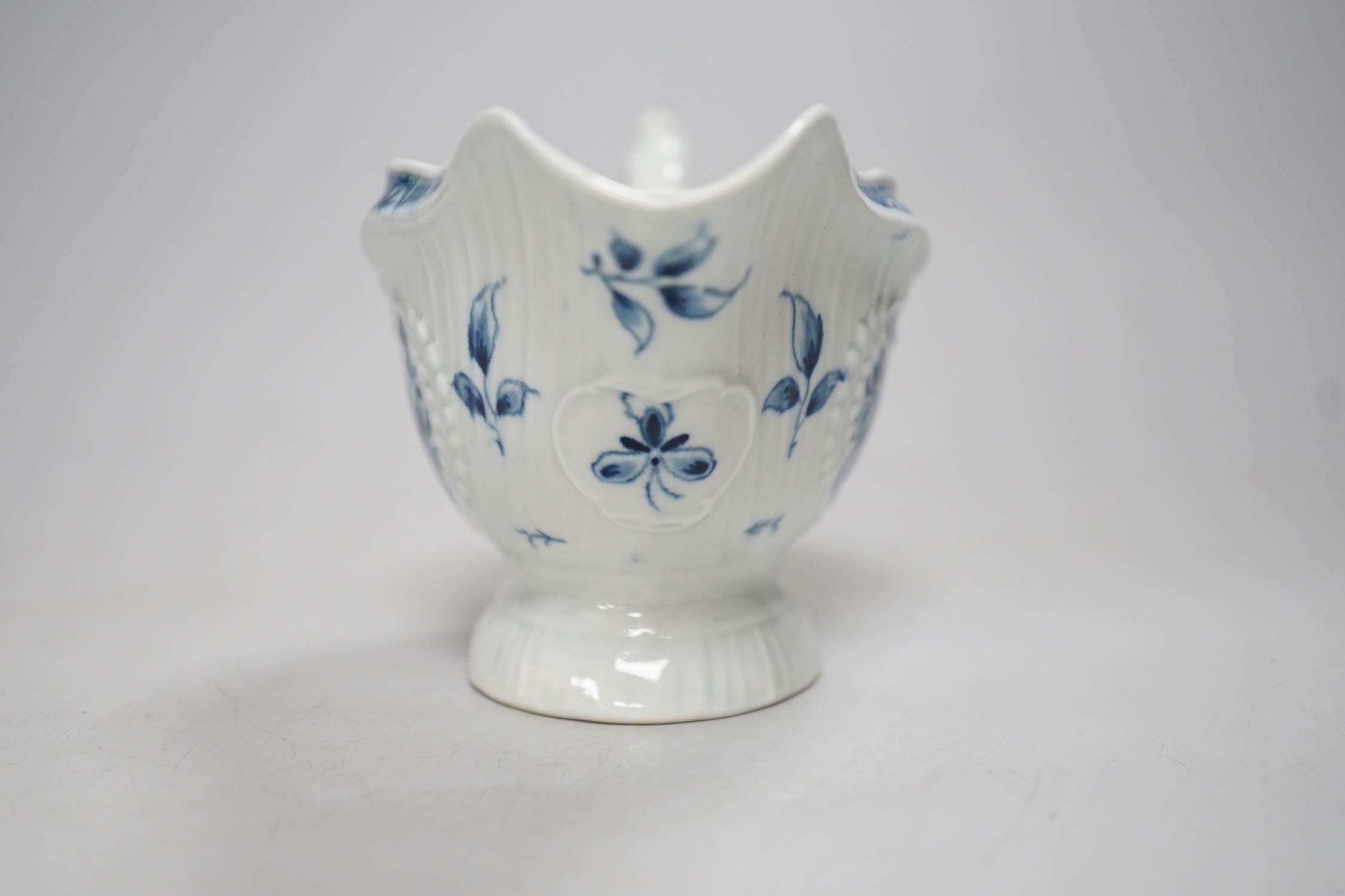 An 18th century Worcester sauceboat painted with the Strap Fluted Floral pattern. 15cm wide